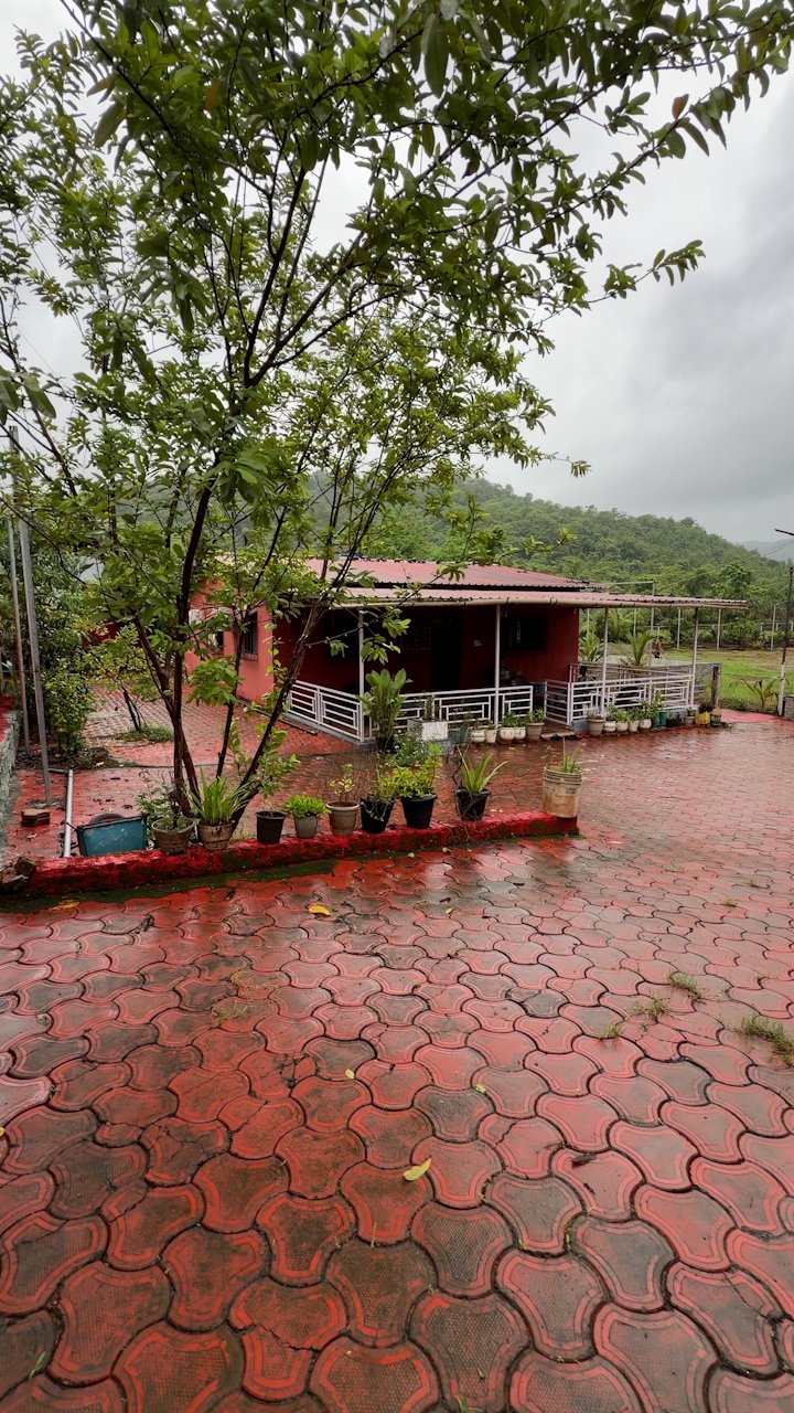 Red brick farmhouse exterior and paved courtyard